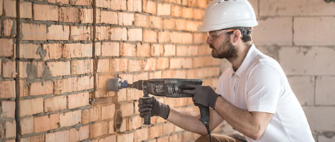 Trabajador de la construcción utilizando un taladro